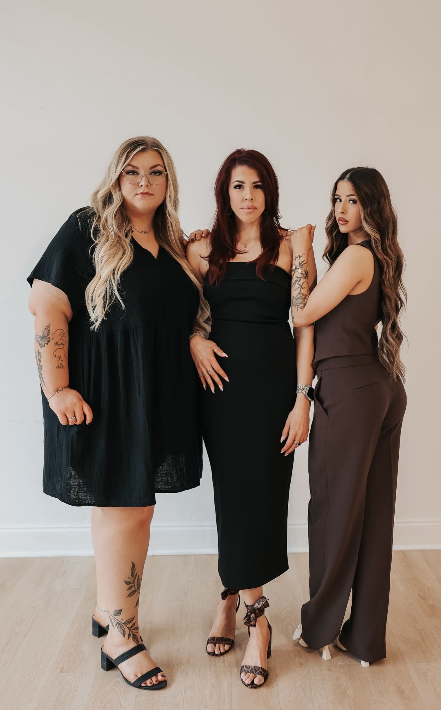 Courtney, Jenn and Emily standing together in the salon